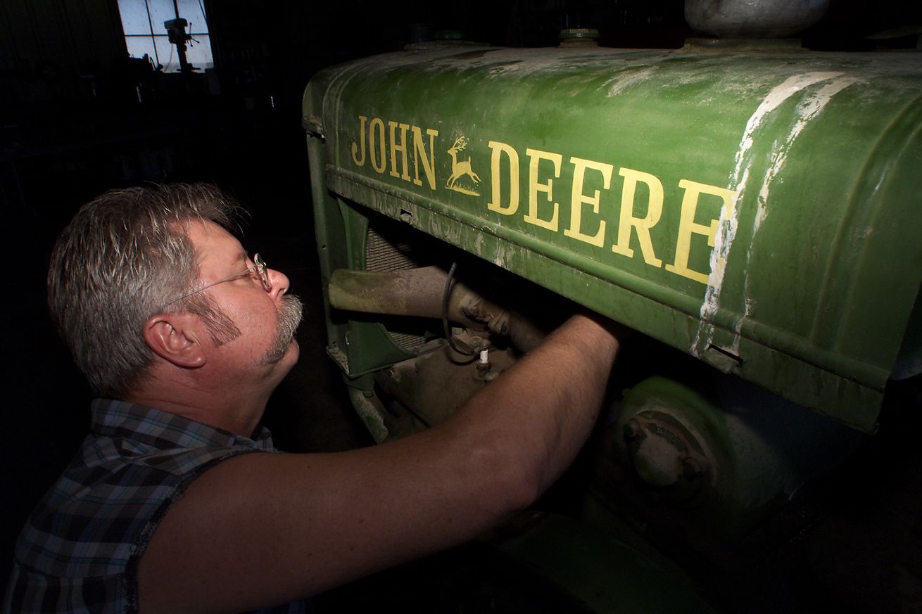 Rusty Relics member David Pickus(CQ) works to install a fuel line for a vintage 1927 John Deere trac