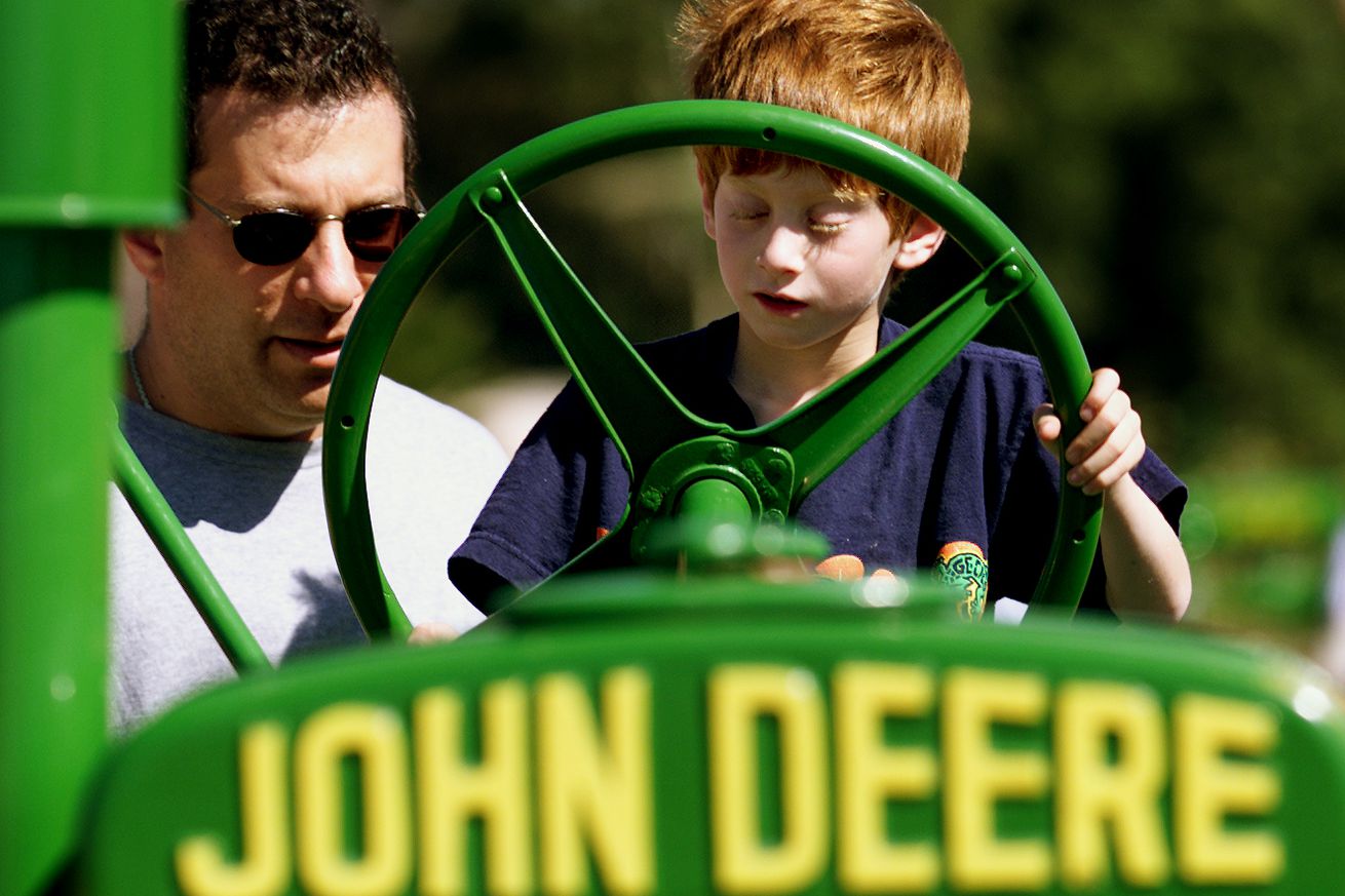 Matthew Gillman,6, and Jeff Gillman got to sit on a restored 1929 John Deere tractor during the Annu